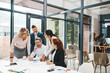 © peopleimages.com - Employees, people and office with documents for strategy with teamwork and collaboration for company growth. Boardroom, paperwork and project managers with report, feedback and results for business