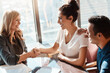 © ReeseArcurs/peopleimages.com - Business deal, shaking hands and happy people in office with support for promotion and trust. Teamwork, man and women in conference room for collaboration and success for partnership in New York