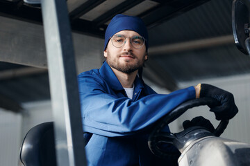 Portrait young man worker driver of forklift on industry factory, Warehouse of food plant