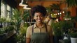 © Muzamil - Portrait of confident Black woman small business owner in plant retail store.