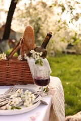 Canvas Print - Stylish table setting with beautiful spring flowers and wine in garden