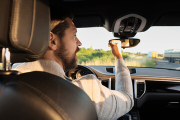 Wall Mural - Man singing in car, view from inside