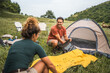 © Miljan Živković - boyfriend and girlfriend set up a tent in nature ready for camping