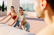 © Xavier Lorenzo - Three young fitness friends doing stretching exercise after workout routine outside. Healthy lifestyle concept