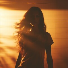 Wall Mural - silhouette of a woman with long hair standing in front of the sun