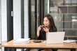 © junjira - Businesswomen  Working and talking about work documents at the office.