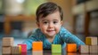 © Thavesak - A playful toddler builds a colorful tower with blocks, enjoying a fun learning activity at home
