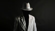 © wanchai - A man wearing a white hat and a white suit is standing in front of a black background. Concept of mystery and elegance, as the man's attire and the hat create a sophisticated and stylish appearance