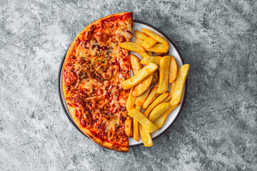 Wall Mural - plate with half pizza half chips, concpet of fast food or unhealthy food with lots of carbs