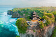 © Konstantin - Uluwatu Temple one of six key Bali temple perched on top mountain cliff on nature background Bali, Indonesia 4K Aerial view
