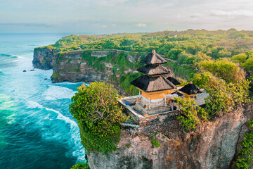 Uluwatu Temple one of six key Bali temple perched on top mountain cliff on nature background Bali, Indonesia 4K Aerial view