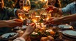 © Pixel Perfect - A group of friends toasting with glasses at an outdoor dining table, celebrating the joy and warmth during social gatherings. A group of friends toasting with glasses at an outdoor dining table
