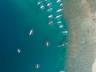 Wall Mural - Aerial view of boats anchored in the bay with clear and turquoise water. Boats in the tropical lagoon. Palawan island, Philippines.