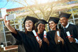 © BestLens/peopleimages.com - Students, graduation and smile with selfie on campus for celebration and success. People, college and happy as university classmate or friends for social media post with qualification certificate