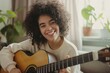 © Iryna - A cheerful teenage girl plays an acoustic guitar at home, enjoying her musical hobby and relaxing.