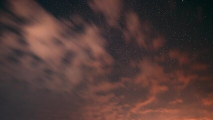 Wall Mural - Fast Running Clouds Timelapse. Amazing Night Starry Sky Transition To Bold Morning Sky. Bright Dramatic Trails Of Stars And Meteors. Sky In Different Colors. From Dusk Till Dawn. Misty Night Time