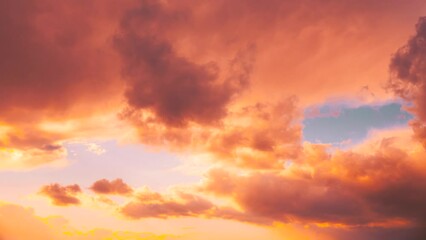 Poster - Saturated Yellow Colors Of Clouds. Time Lapse Time-lapse Time-lapse. Unusual Sky Background. Rich Colors Pink Colors. Sky Sunset Sunrise Background. 4k Timelapse Toned Pink-yellow Clouds. Toned