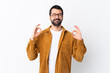 © luismolinero - Caucasian handsome man with beard wearing a corduroy jacket over isolated white background in zen pose