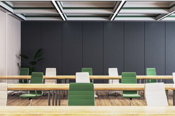 Poster - A modern classroom interior with rows of empty green and white chairs, wooden desks, and a minimalist black wall on a wooden floor, concept of education. 3D Rendering