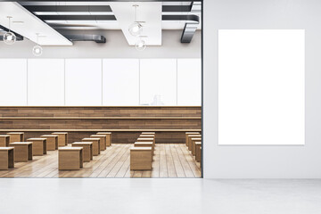 Wall Mural - An empty auditorium with wooden benches and a large blank white banner on a white wall, modern interior design, education concept. 3D Rendering