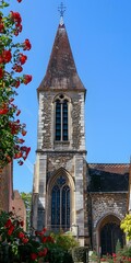 A beautiful church with red flowers in the foreground