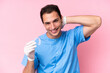 © luismolinero - Dentist caucasian man holding invisible braces isolated on pink background laughing