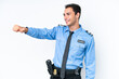 © luismolinero - Young police caucasian man isolated on white background giving a thumbs up gesture
