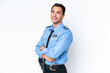 © luismolinero - Young police caucasian man isolated on white background with arms crossed and looking forward