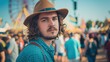 © ANC Media - A young man with curly hair wearing a hat stands out amongst the crowd at Oktoberfest