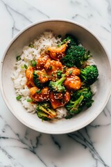 Wall Mural - Overhead photo saucy korean chicken with rice and broccoli in a white bowl on a white marble background