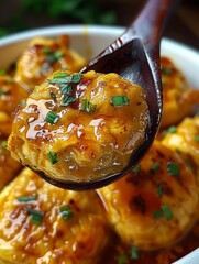 Wall Mural - Close up view of a cooked dish, savory golden colored item possibly a type of dumpling or pastry surrounded by a sauce or glaze