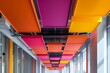 © juni studio - A ceiling with suspended acoustic baffles in vibrant colors, enhancing both aesthetics and acoustics.