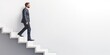 © Andrii Zastrozhnov - Successful businessman walking down stairs signifies career growth and progress.