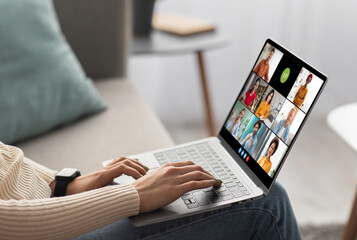 Poster - Woman participating in a video conference meeting on her laptop. The screen of the laptop shows the faces of multiple people, each in a separate video window