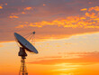 © niwat - Twilight radio telescope silhouette against orange sky