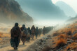 © Kmikhidov - A group of pilgrims walk in single file along a dusty trail through a mountain pass shrouded in mist