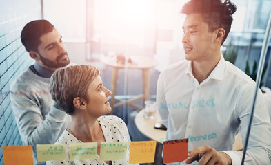 Poster - Teamwork, brainstorming and business people with glass board, project ideas or sticky note in office. Lens flare, diversity and group of employees in meeting for planning, agenda or collaboration