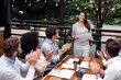 © peopleimages.com - Cafe, business people and applause for presentation, woman and feedback report for finance project. Restaurant, professional career and accountant for training, staff and solidarity with document