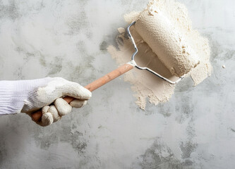 paint roller brush against white  wall