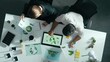 © Summit Art Creations - Top down view of business man presenting sustainable idea to manager by using tablet display ESG environmental social governance. Manager working together planning to use clean energy. Alimentation.