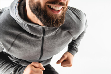 Wall Mural - Smiling Man Running in Gray Hoodie