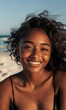 © Grigor - Portrait of a beautiful smiling young woman with dark skin on the beach,