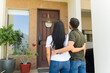 © AntonioDiaz - Joyful couple embraces in front of their new home, radiating love and excitement. This moment captures success, achievement, and a new chapter in their lives