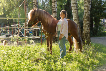 Wall Mural - Woman with the Icelandig horse beside the pasture during the sunset