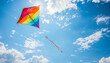 © Sana Sabina - Flying a colorful bright kite in the bright sky with clouds.