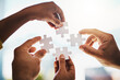 © Penn/peopleimages.com - Business people, hands and puzzle in office with collaboration, problem solving and project management. Employees, jigsaw piece zoom and teamwork for synergy with solidarity, integration and strategy