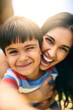 © JorSons/peopleimages.com - Mother, boy and child with selfie outdoor for weekend fun, memory and happiness for bonding with love or care. Mom, male kid and photography with embrace or security, childhood and affection with joy
