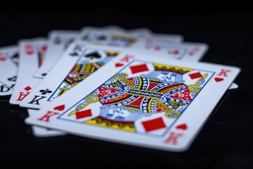 Poster - A stack of playing cards resting on a tabletop surface