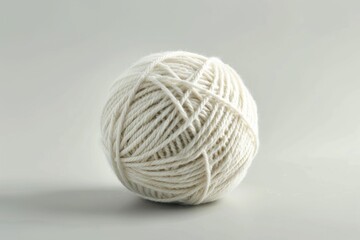 Poster - A ball of yarn sits on a clean white surface, ready for crafting or knitting