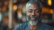 © Dusan - A middle-aged man with a gray beard and a warm, friendly smile. He appears relaxed and content, wearing a casual shirt in an inviting environment with soft bokeh background.